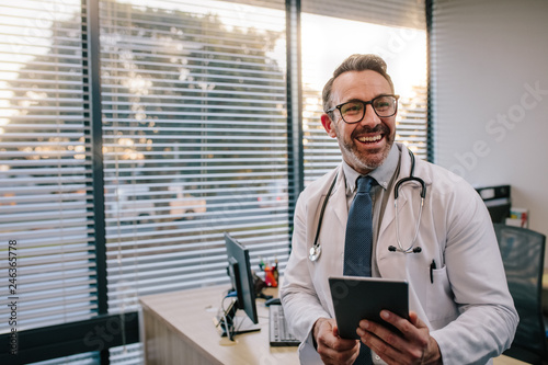 Doctor with digital tablet in his office