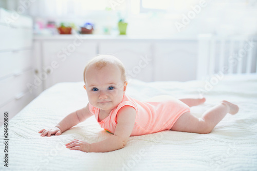 Cute baby girl lying on her tummy