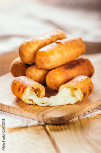 Cheese fingers, typical Venezuelan appetizer called tequeños on a wooden board