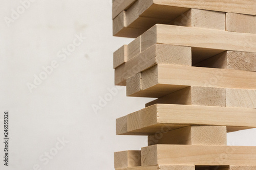 Board game jenga. Wooden blocks. A logic game for two and a company. Entertainment for adults and children. Useful leisure. Educational toys. Wooden bricks. Tower of cubes.