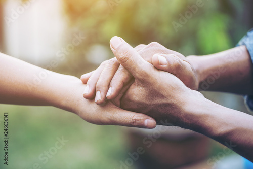 Two young lovers holding hands with blur backgroung