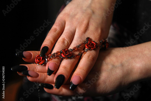 Women's hands with nail arts on nails holding costume jewelry