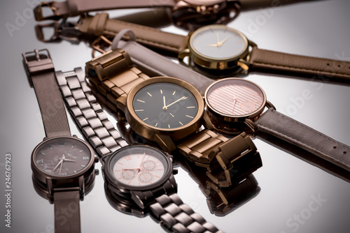 selective focus of luxury wristwatches on grey background