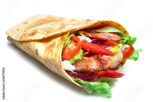 Shawarma sandwich isolated on white background. Gyro fresh roll with pita with grilled chicke, lettuce salad, bacon, tomato, sauces, cheese and vegetables.