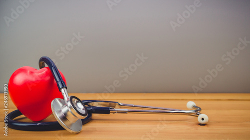 Close up red heart and steythoscope on old wood table and world health day and healthcare technology concept, vintage tone - Image