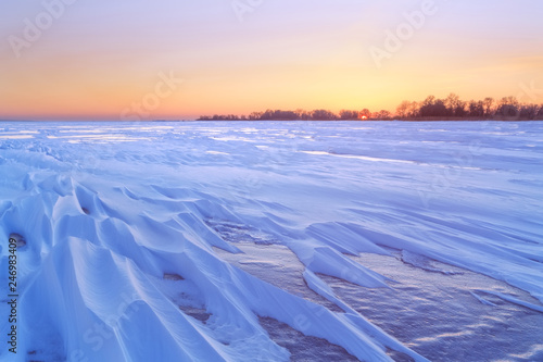 dawn on the frozen lake early morning / winter bright landscape nature