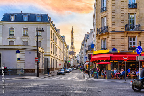 Cozy street with tables of cafe in Paris, France. Architecture and landmark of Paris. Cozy Paris cityscape.