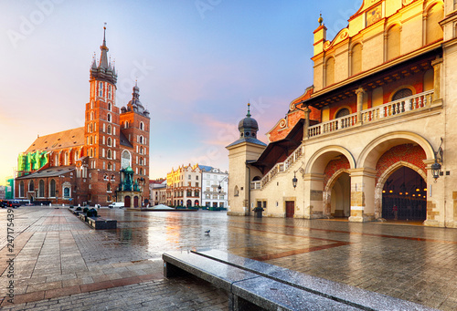 Old city center view with Adam Mickiewicz monument and St. Mary's Basilica in Krakow on the morning