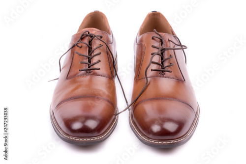Classic leather elegant shoe on a white background. Beautiful brown luxury and casual leather men shoes. Fashion accessory. Closeup, front view.Both leg. Isolated. 
