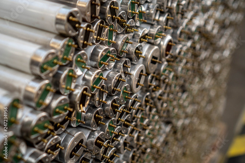Old fluorescent lamps are stacked in rows. Background view