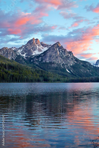 Sunset reflecting in lake over the Sawtooth Mountains near Stanley Idaho, USA