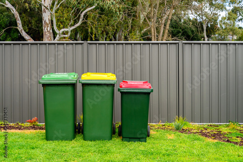 Australian home wheelie bins set provided by local council on back yard 