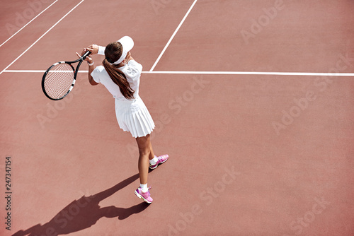 Waiting for the return. Young woman play tennis