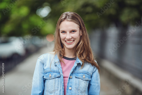 Wonderful casual teenage woman smiling at camera
