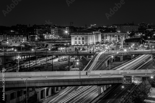 View of Penn Station and the Jones Falls Expressway at night, in Midtown Baltimore, Maryland.