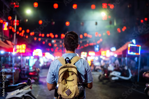 Traveler exploring Asian food market street