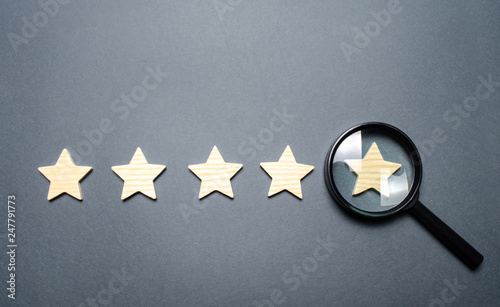 Five stars and a magnifying glass on the last star. Check the credibility of the rating or status of the institution, hotel, restaurant. Auditing, testing and certification. Getting the fifth star.