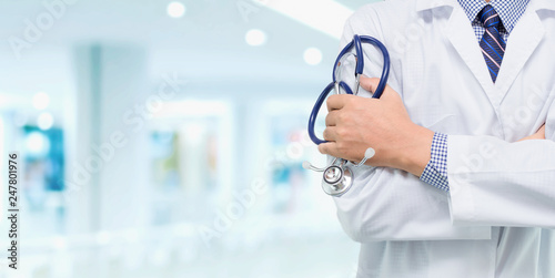 Doctor with a stethoscope in the hands behind on the hospital background / Medical concepts and health care