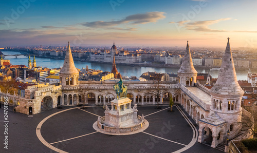 Budapest, Hungary - The famous Fisherman's Bastion at sunrise with statue of King Stephen I and Parliament of Hungary at background