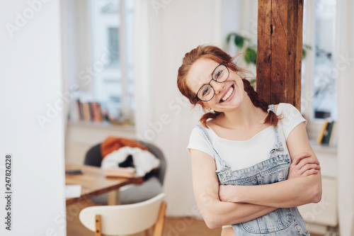 happy confident young woman with folded arms