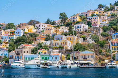 Sail boats, yachts and colorful houses in harbor town of Symi (Symi Island, Greece)