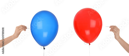 Women piercing colorful balloons on white background