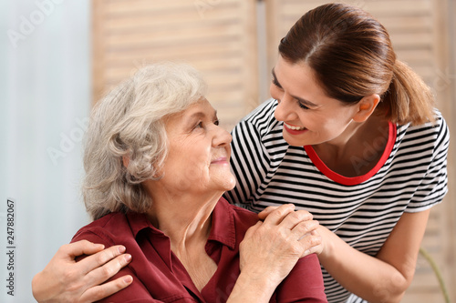 Elderly woman with female caregiver at home