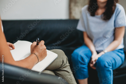 Psychotherapy session, woman talking to his psychologist in the studio