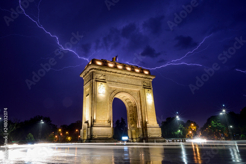 Lightning storm in Bucharest city , Romania with triumphal arch 