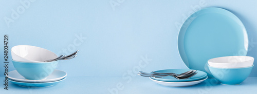 Crockery and cutlery on a blue pastel background
