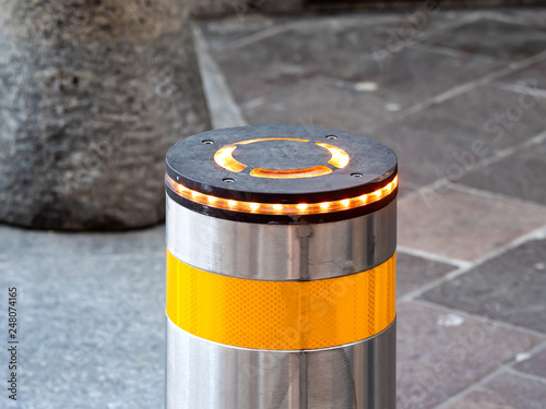 Automatic retractable bollard with glowing lights for control of road traffic and parking.Light, Architecture, Automatic, Blocking, Bollard