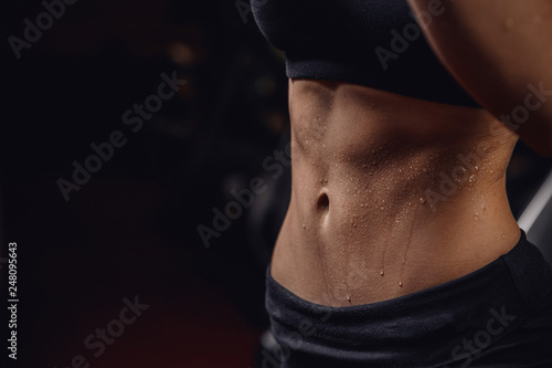 Inflated body fitness of young woman, abdominal muscles dices. Concept sweat after exercise