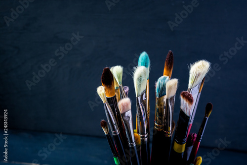 Row of artist paint brushes background