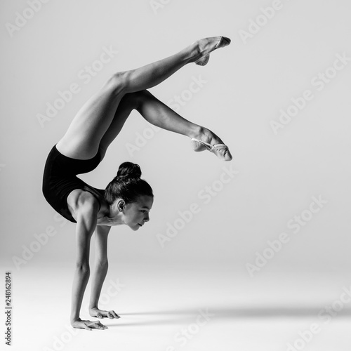 Young gymnast girl stretching and training