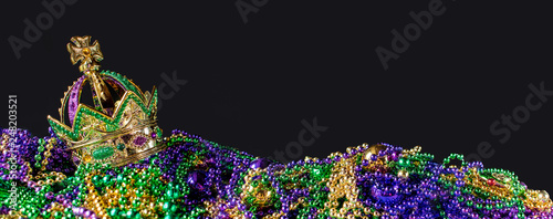 New Orleans mardi gras crown and beads in green, gold, and purple