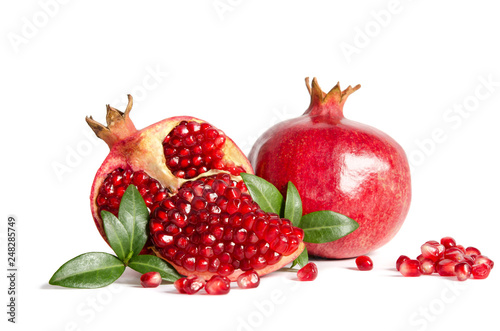 whole Pomegranate and parts of Pomegranate with leaves and seeds isolated on white