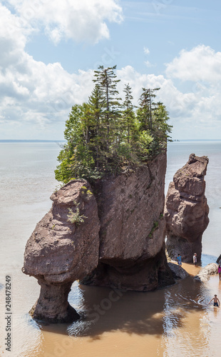 New Brunswick, Canada - August 5, 2017: View of Hopewell rocks, also called the Flowerpots Rocks, caused by tidal erosion in The Hopewell Rocks Ocean Tidal Exploration Site.