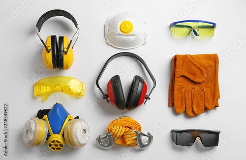 Flat lay composition with safety equipment on white background