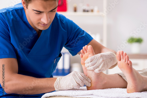 Podiatrist treating feet during procedure