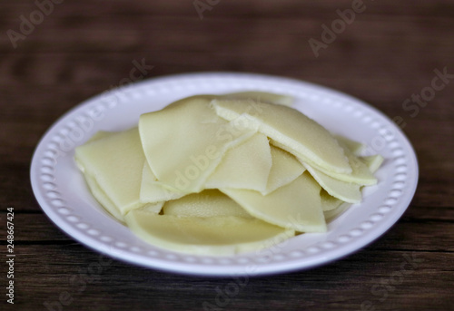 Bamboo shoots on wood background. Ready to cook.