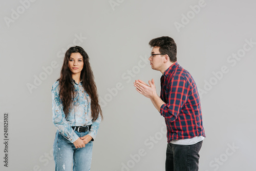 the husband asks for forgiveness from his wife, familiar problems, isolated on the gray background