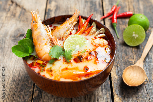 Tom Yam Kung ,Prawn and lemon soup with mushrooms, thai food in wooden bowl top view