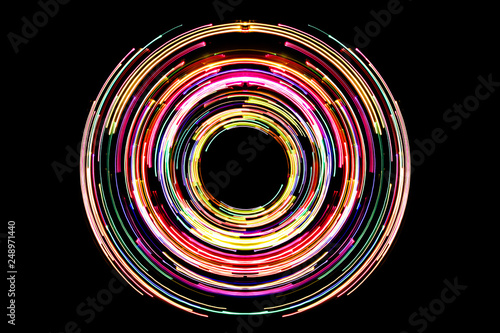 Abstract neon circle lines with empty copy space inside isolated on black background. Colorful led lights long exposure rotation photo.