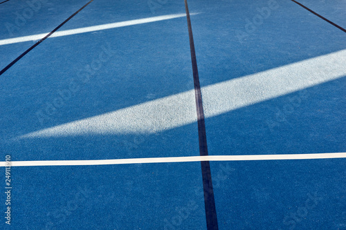 Colorful gym floor with diagonal color blocks. Background texture. Blue, black, white and yellow colors. Exercise concept, indoors sports, gymnastics. Bright and cheerful.