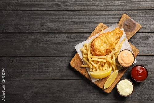 British traditional fish and potato chips on wooden background, top view with space for text