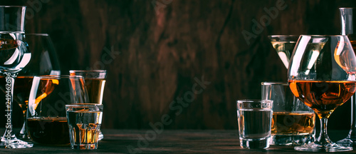 Selection of hard strong alcoholic drinks in big glasses and small shot glass in assortent: vodka, cognac, tequila, brandy and whiskey, grappa, liqueur, vermouth, tincture, rum. 