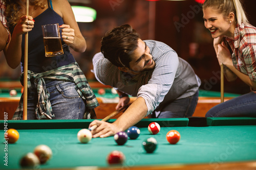 handsome smiling man playing billiard game.