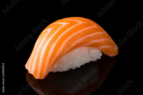 Delicious Sushi Nigiri with Salmon (Sake) on black background. Traditional Japanese cuisine