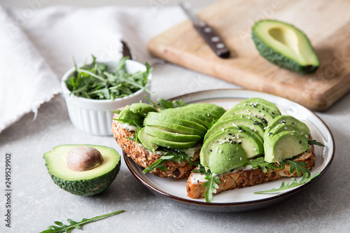 healthy breakfast with avocado and Delicious wholewheat toast. sliced avocado on toast bread with spices. Mexican cuisine
