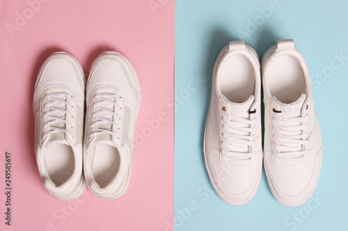  Men's and women's sneakers on a colored background top view. Sport shoes. White running shoes